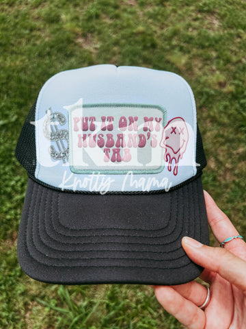 Put It On My Husbands Tab Trucker Hat